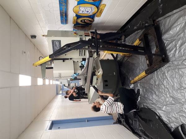 Vacuuming metal shavings out of our new CNC mill